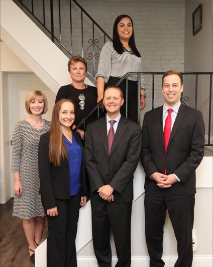 Smith Law Offices staff standing on a stairwell.